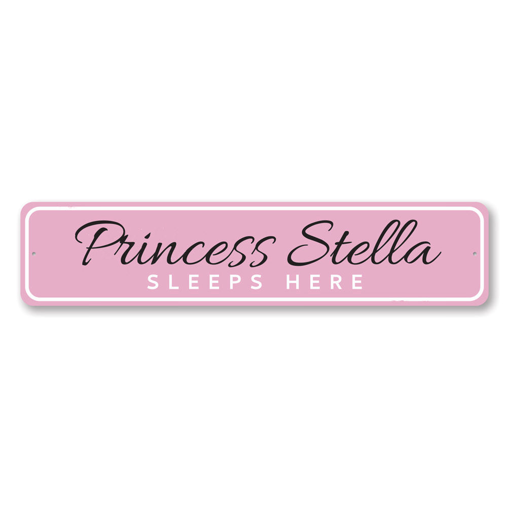 A decorative metal sign reading 'Princess Sleeps Here', featuring a charming design suitable for a child's room.