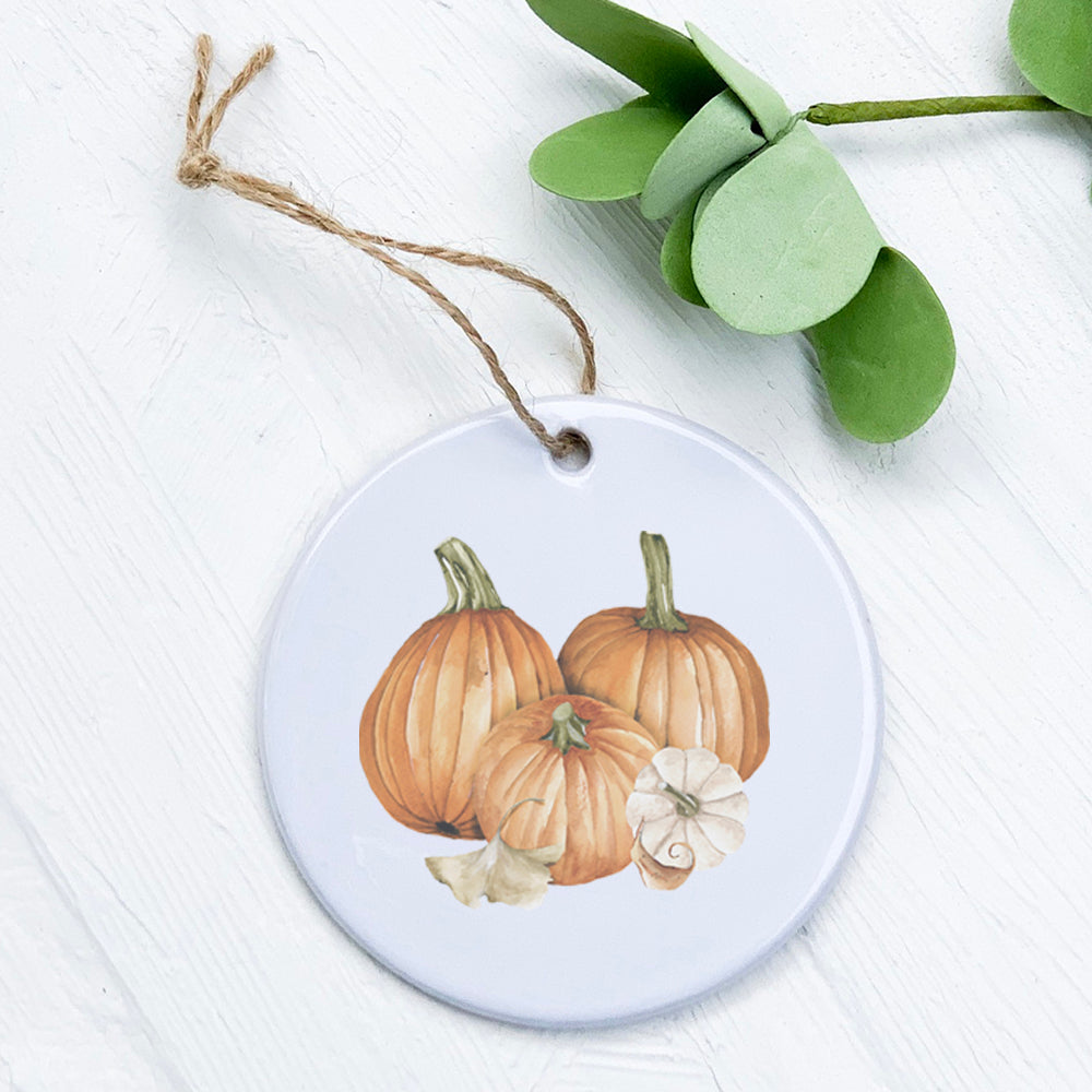 A beautifully crafted Pumpkin Harvest porcelain ornament featuring vibrant autumn colors and intricate design, perfect for seasonal decor.