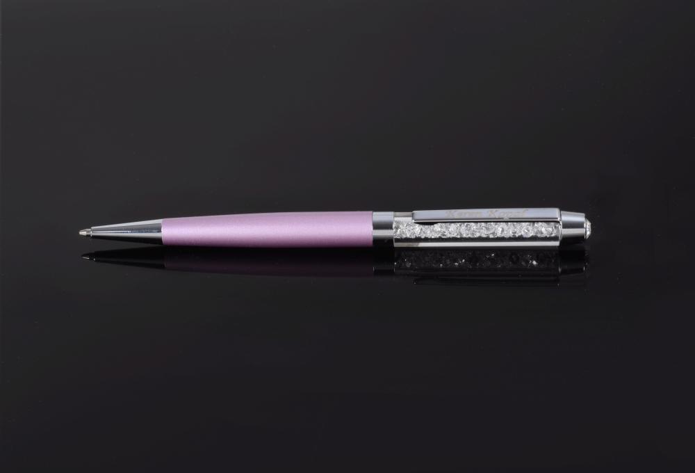 A luxurious purple pen adorned with sparkling Swarovski crystals, elegantly displayed in a black gift box.