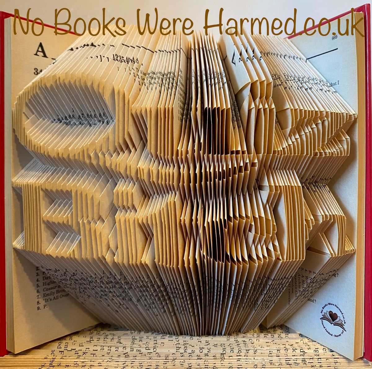 A unique piece of hand-folded book art made from vintage books, showcasing intricate designs and craftsmanship.