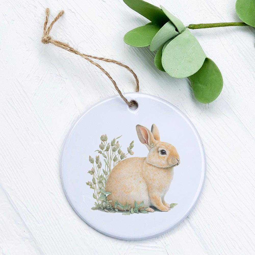 A charming porcelain ornament featuring a rabbit in grass, showcasing vibrant colors and a glossy finish.