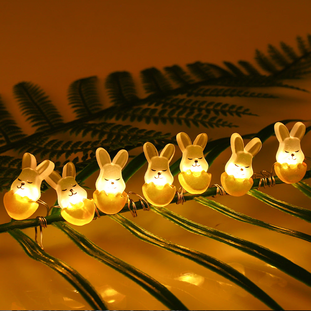 A string of 30 LED fairy lights shaped like rabbits and eggs, glowing warmly, perfect for Easter decorations.