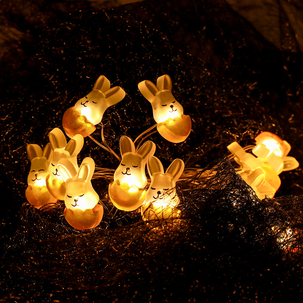 A string of 30 LED fairy lights shaped like rabbits and eggs, glowing warmly, perfect for Easter decorations.