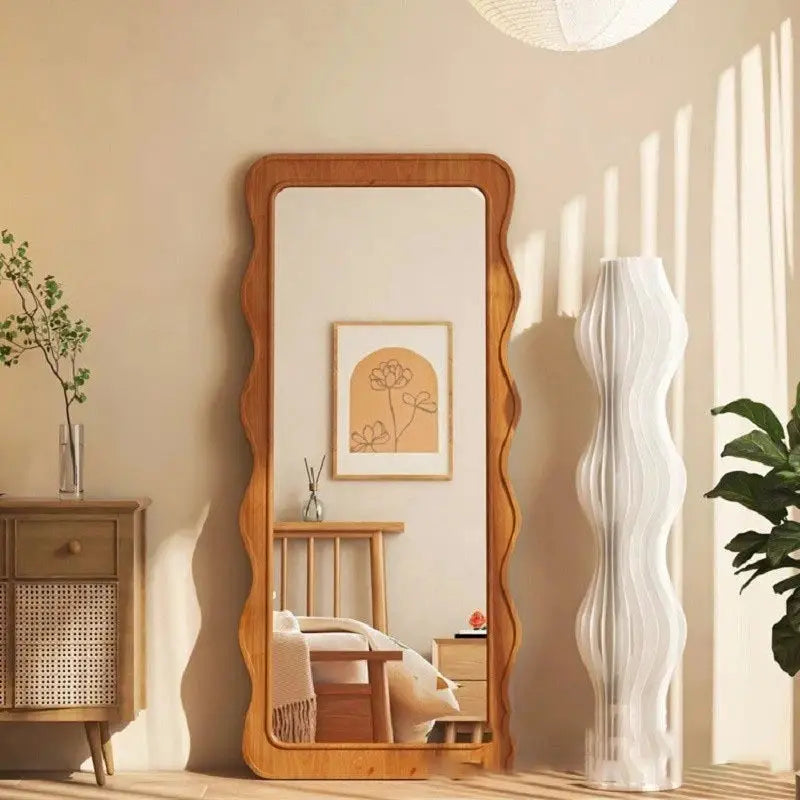 The Ramilli Mirror featuring a hand-carved solid pine wood frame with intricate grain patterns, reflecting a serene Scandinavian design.