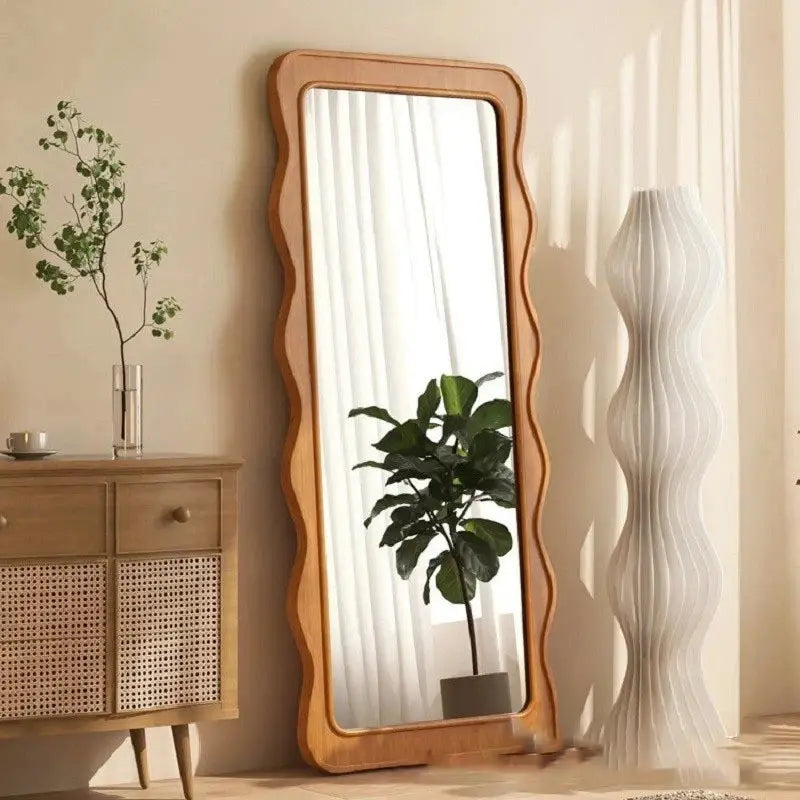 The Ramilli Mirror featuring a hand-carved solid pine wood frame with intricate grain patterns, reflecting a serene Scandinavian design.