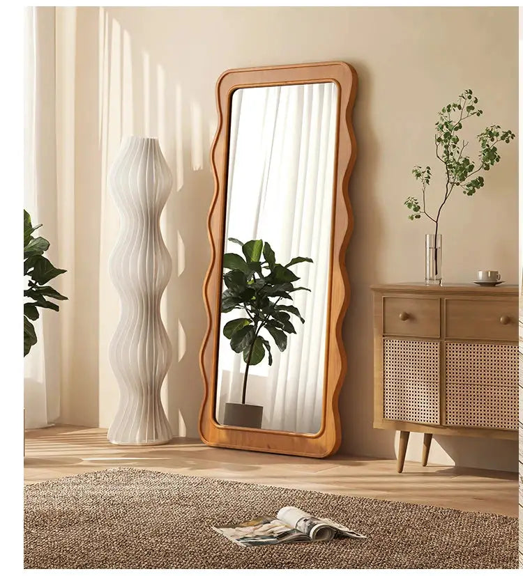 The Ramilli Mirror featuring a hand-carved solid pine wood frame with intricate grain patterns, reflecting a serene Scandinavian design.