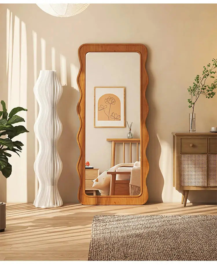 The Ramilli Mirror featuring a hand-carved solid pine wood frame with intricate grain patterns, reflecting a serene Scandinavian design.