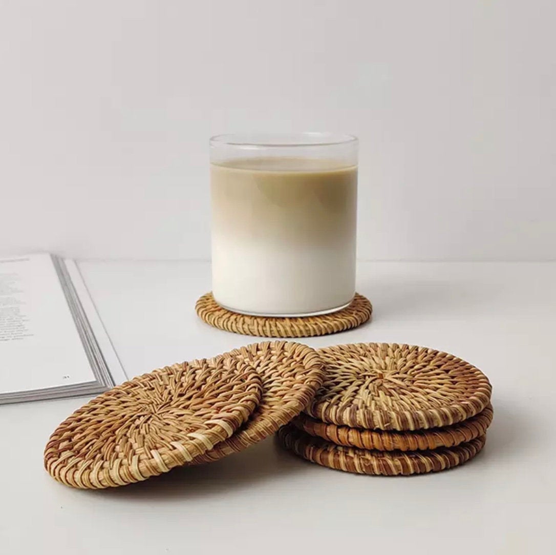 Set of 4 handmade rattan coasters, showcasing their natural texture and elegant design, perfect for table décor.