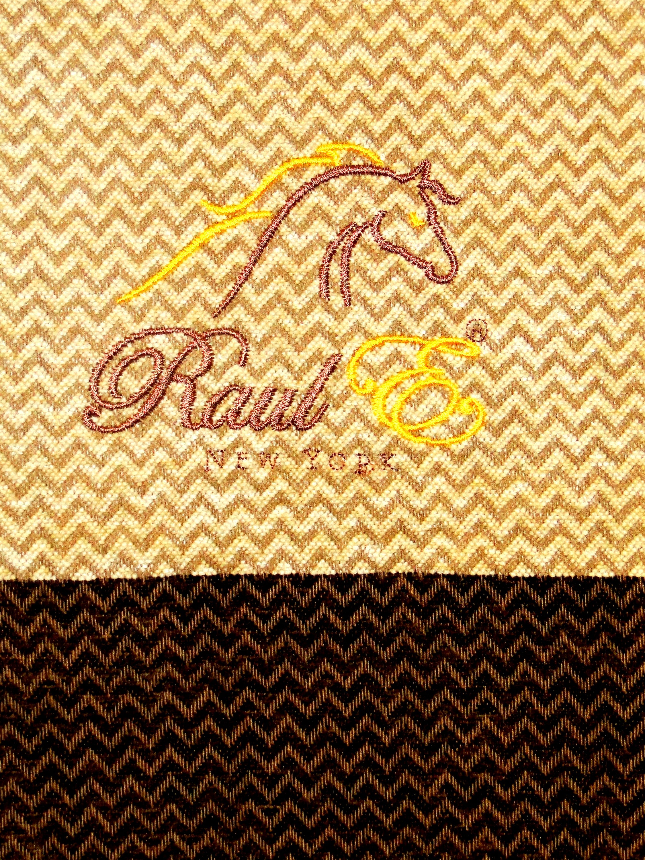 Raul E New York luxury blanket featuring a chenille herringbone design with fringed edges, available in various colors.