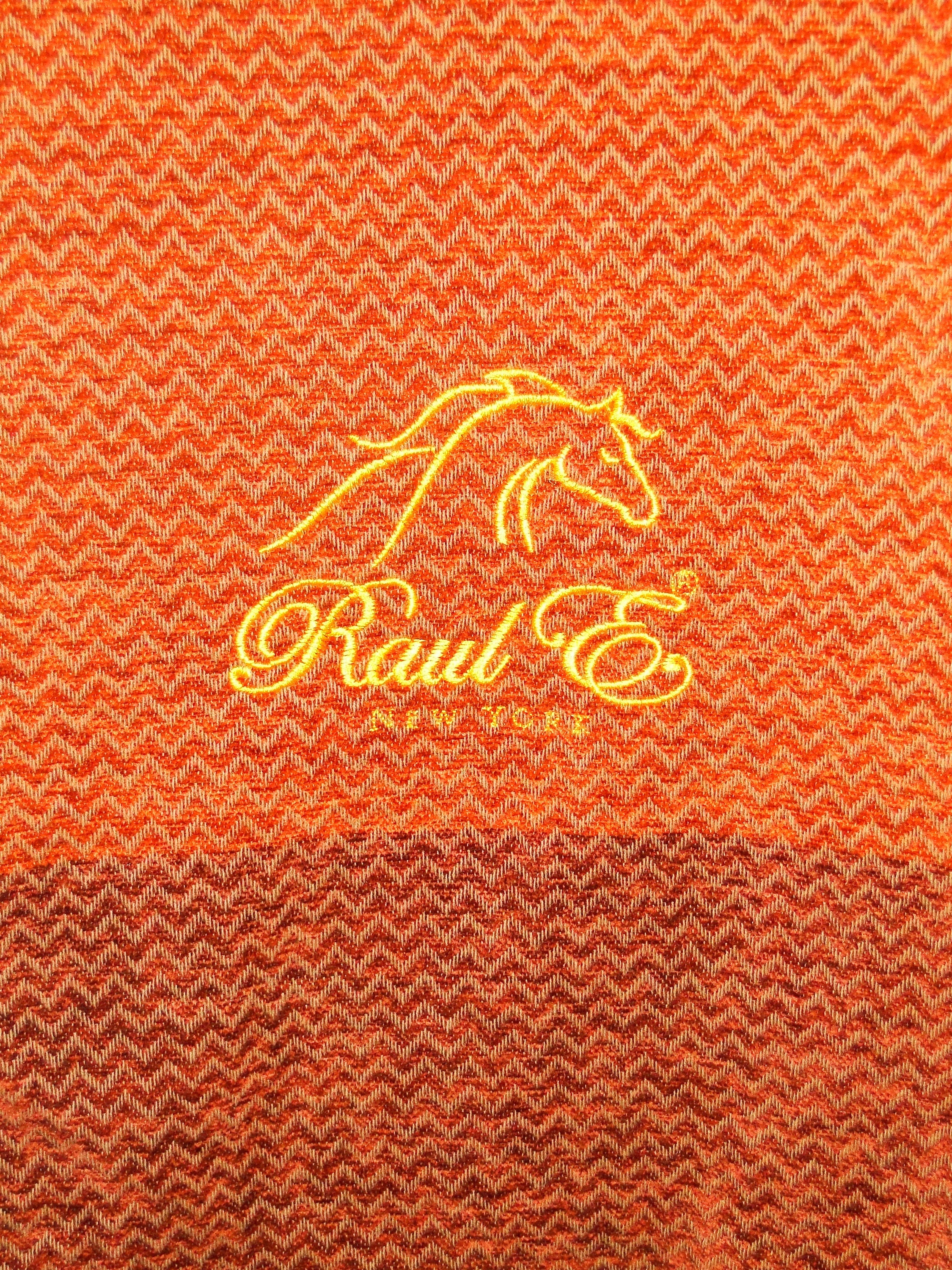 Raul E New York luxury blanket featuring a chenille herringbone design with fringed edges, available in various colors.