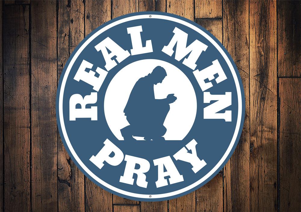 Real Men Pray Sign made of aluminum, featuring a bold design suitable for home decor.