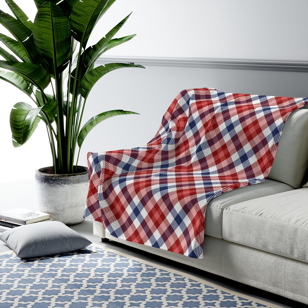 A cozy red and blue plaid plush blanket throw draped elegantly over a couch, showcasing its soft velveteen texture and stylish design.