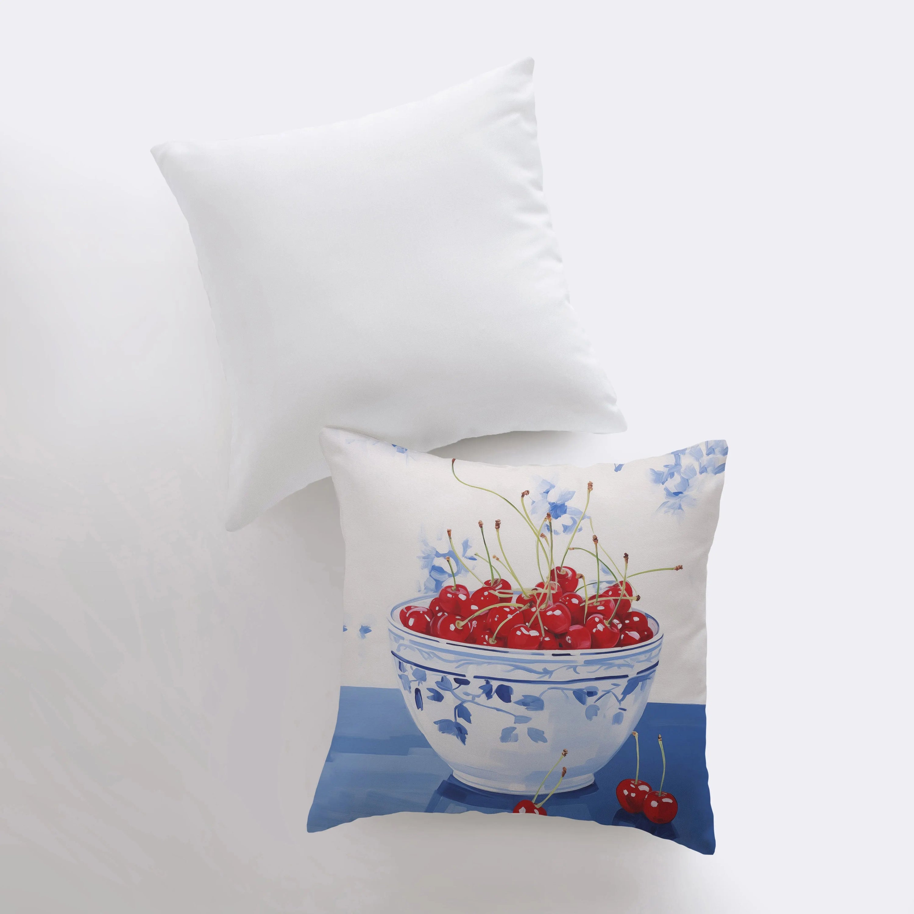 A vibrant Red Cherry Bowl pillow featuring a gouache painting design, showcasing cherries in a bowl against a white background.