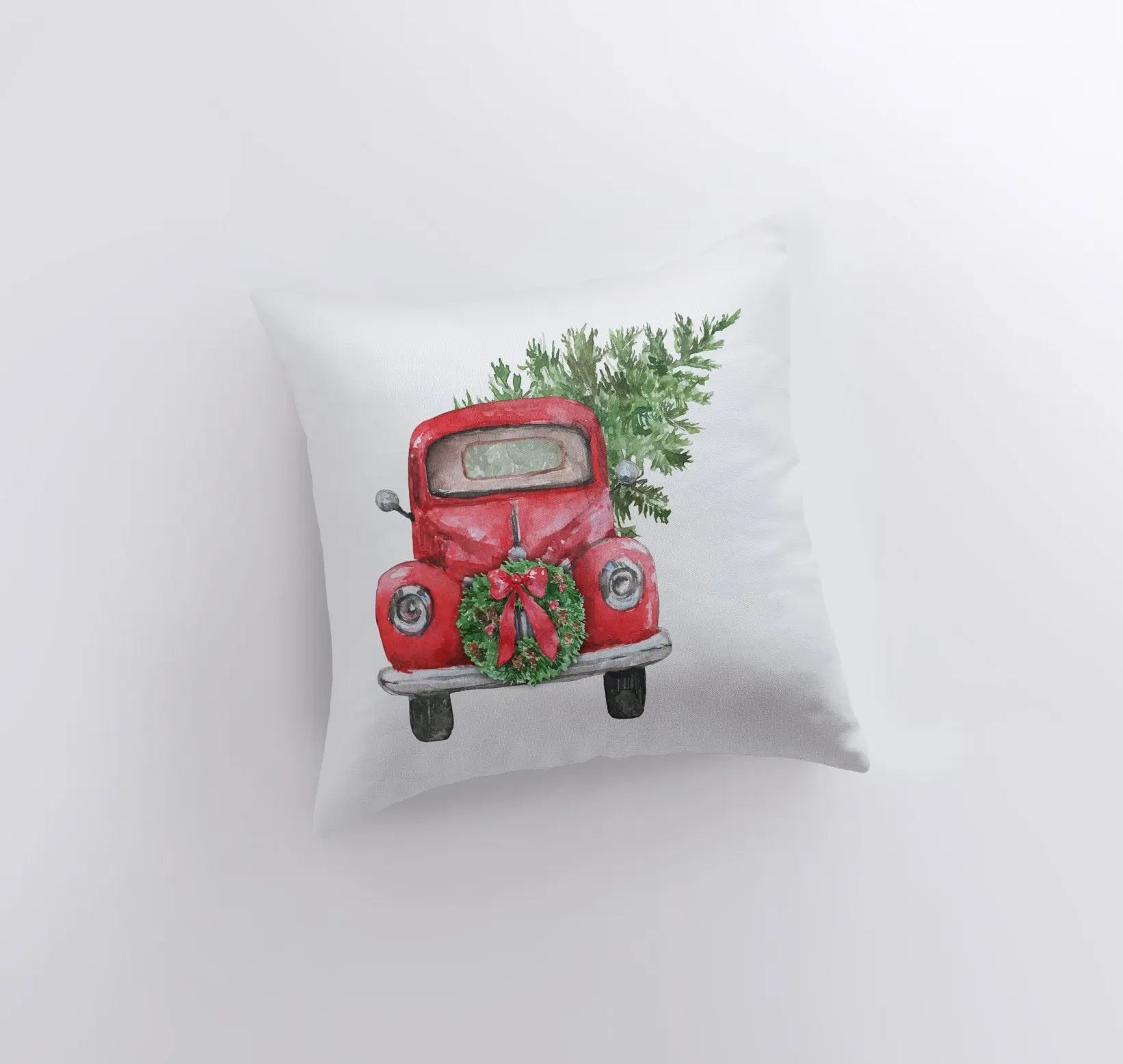 Red Christmas Truck Pillow Cover featuring a vintage truck hauling a Christmas tree and wreath, set against a white background.