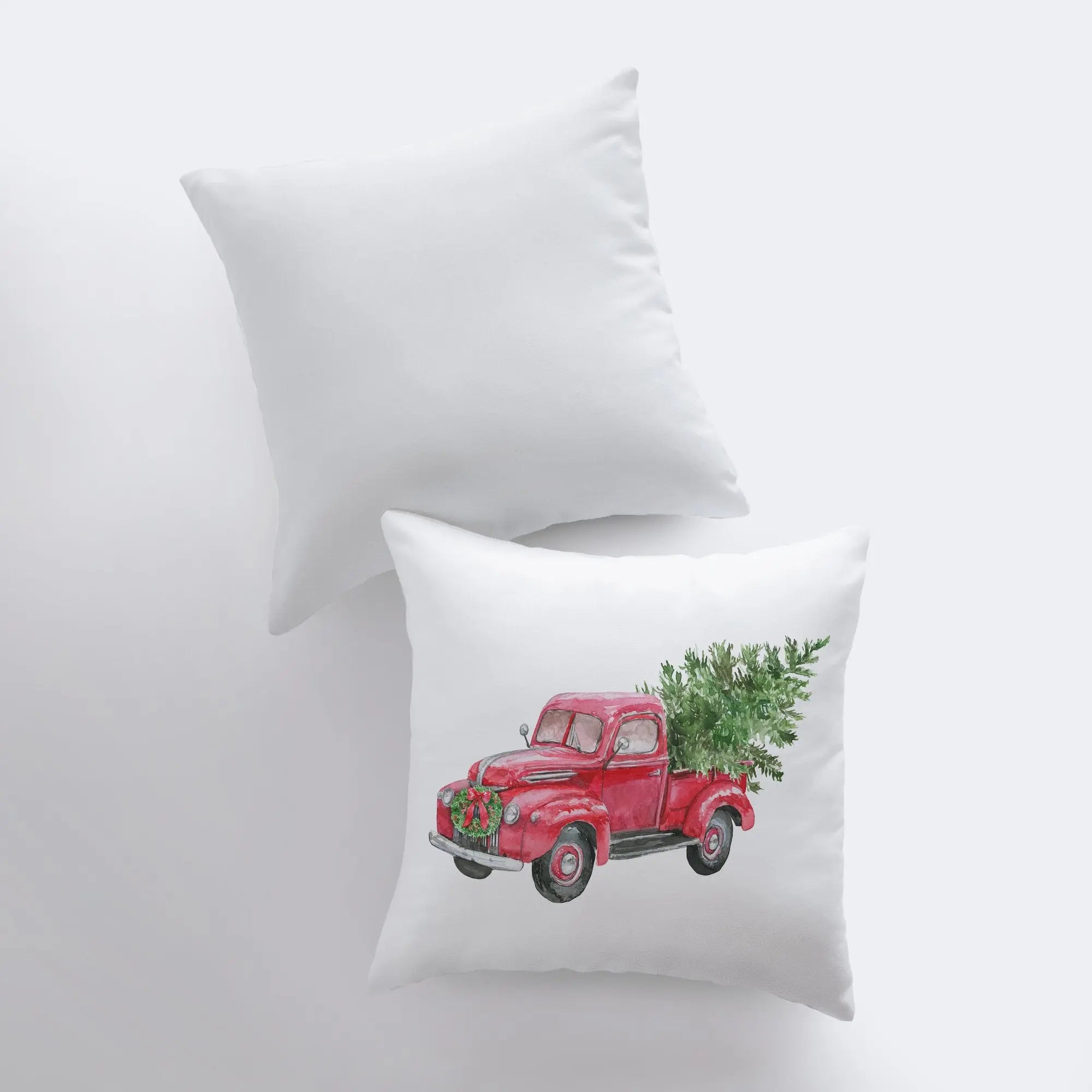 Red Christmas truck hauling a Christmas tree, featured on a decorative pillow cover with a solid white back.