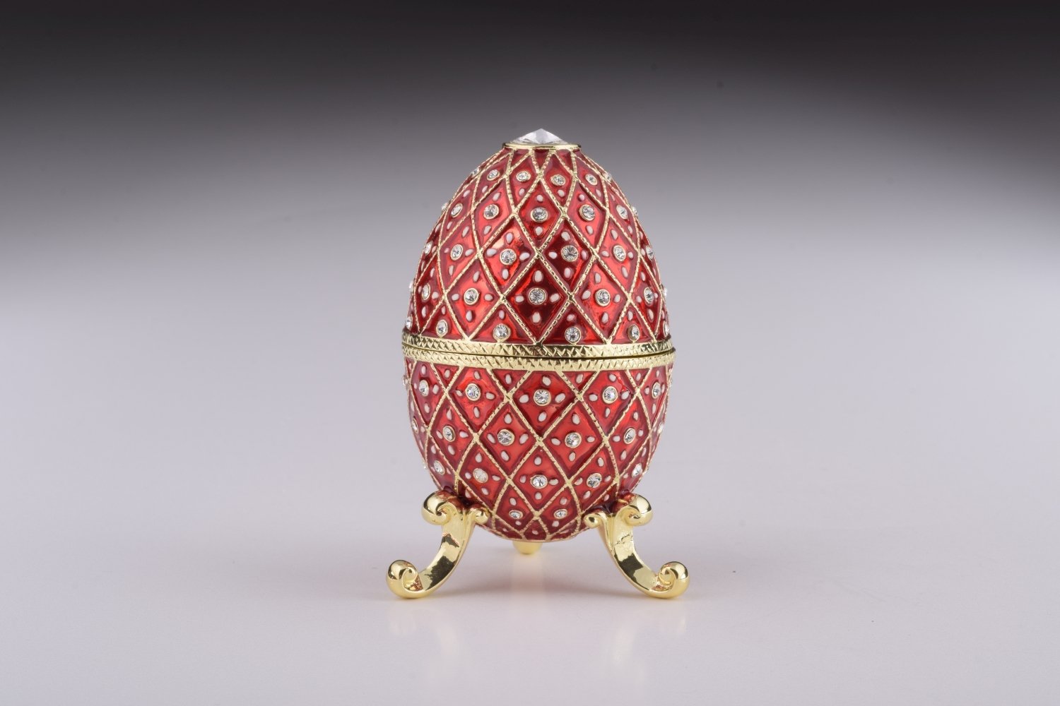 A stunning Red Faberge Egg trinket box featuring a horse carousel surprise inside, adorned with Austrian crystals and 24K gold plating.