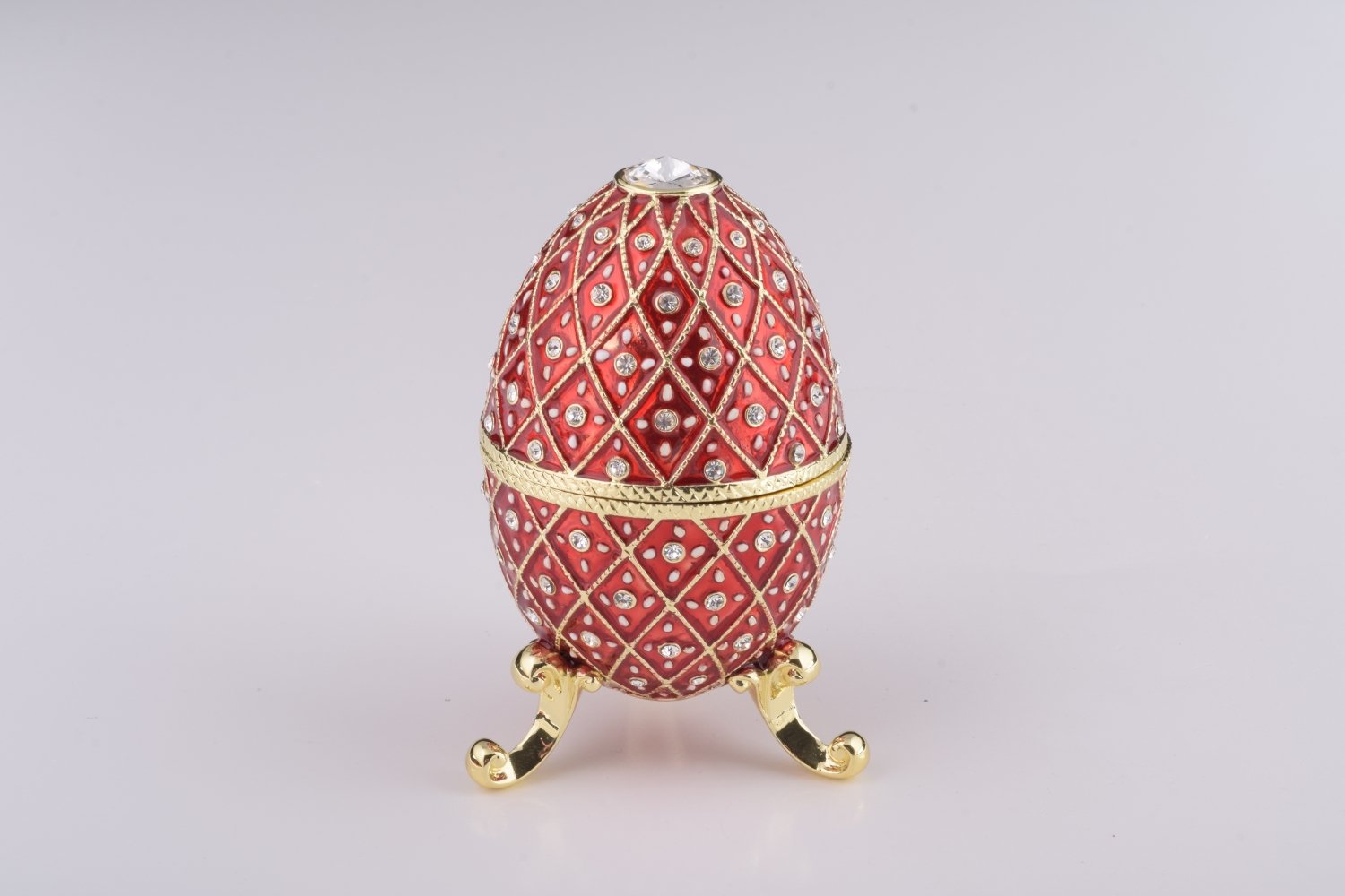 A stunning Red Faberge Egg trinket box featuring a horse carousel surprise inside, adorned with Austrian crystals and 24K gold plating.