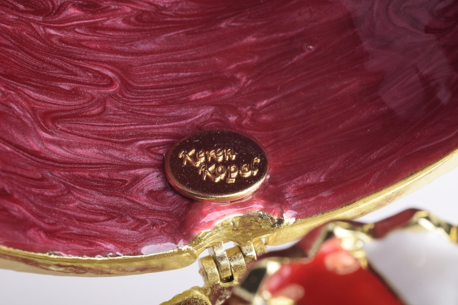 A stunning Red Faberge Egg trinket box featuring a horse carousel surprise inside, adorned with Austrian crystals and 24K gold plating.