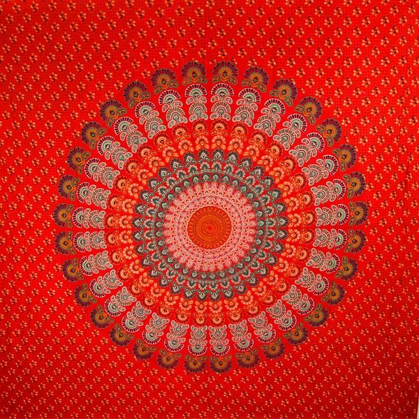 A vibrant red mandala tapestry featuring intricate peacock feather designs, showcasing rich colors and detailed patterns, perfect for home decor.