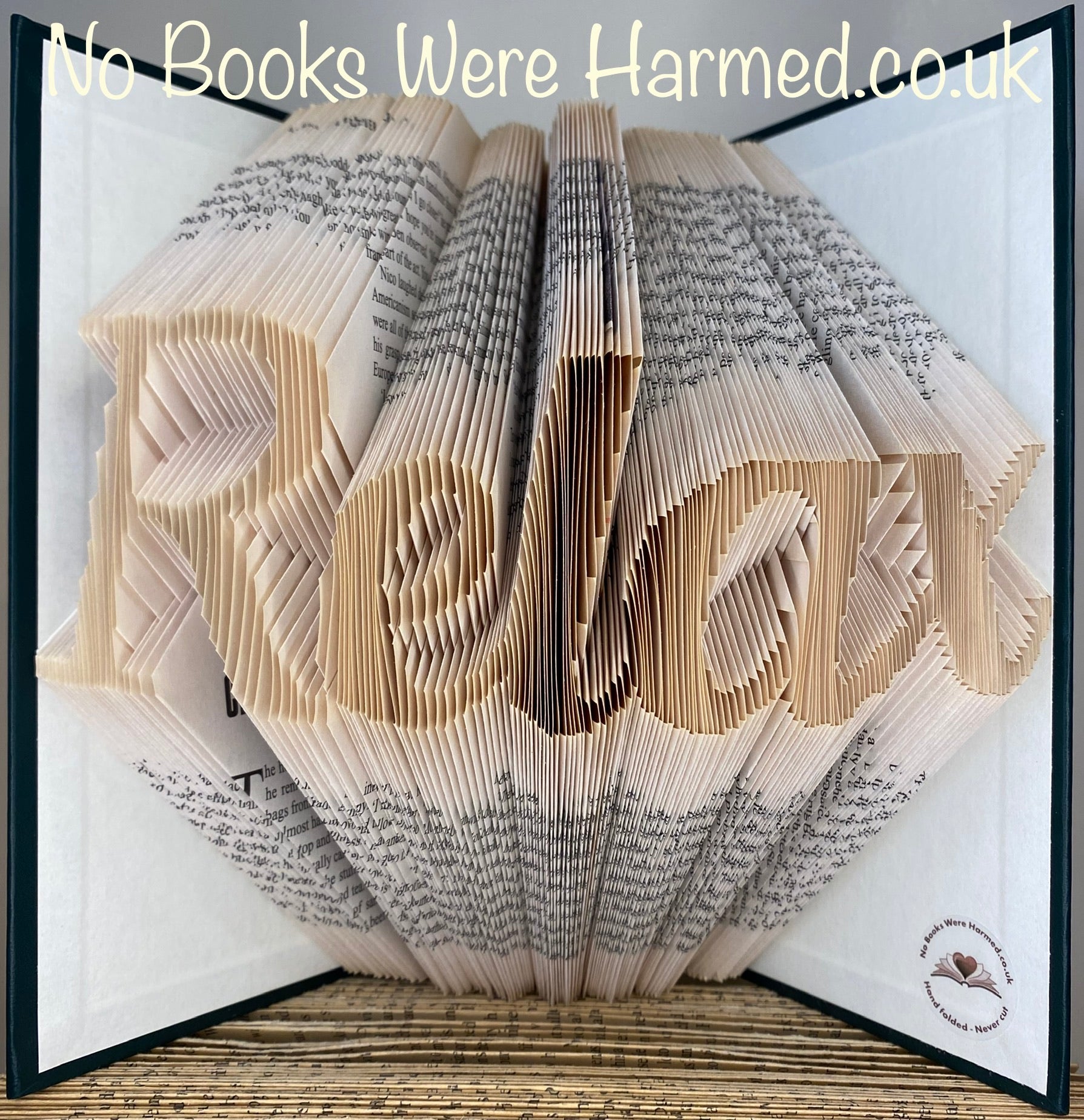 Hand-folded book art piece from the Relax collection, showcasing intricate designs made from vintage book pages.