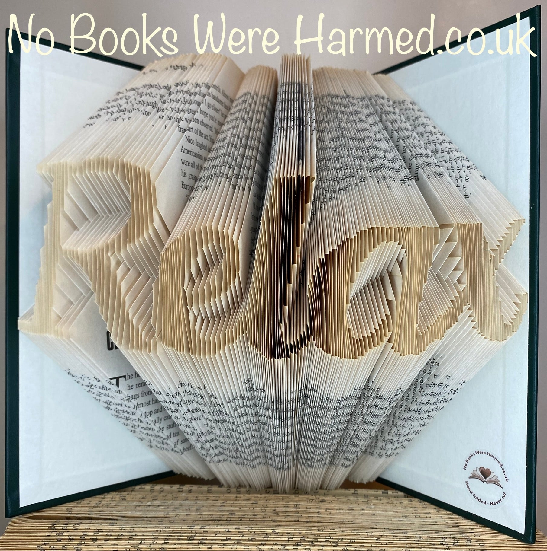 Hand-folded book art piece from the Relax collection, showcasing intricate designs made from vintage book pages.