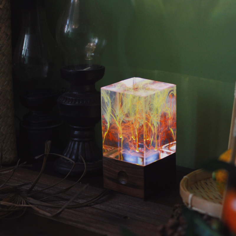 Handcrafted resin table decor featuring solar-powered LED lights in a unique design, showcasing warm white illumination.