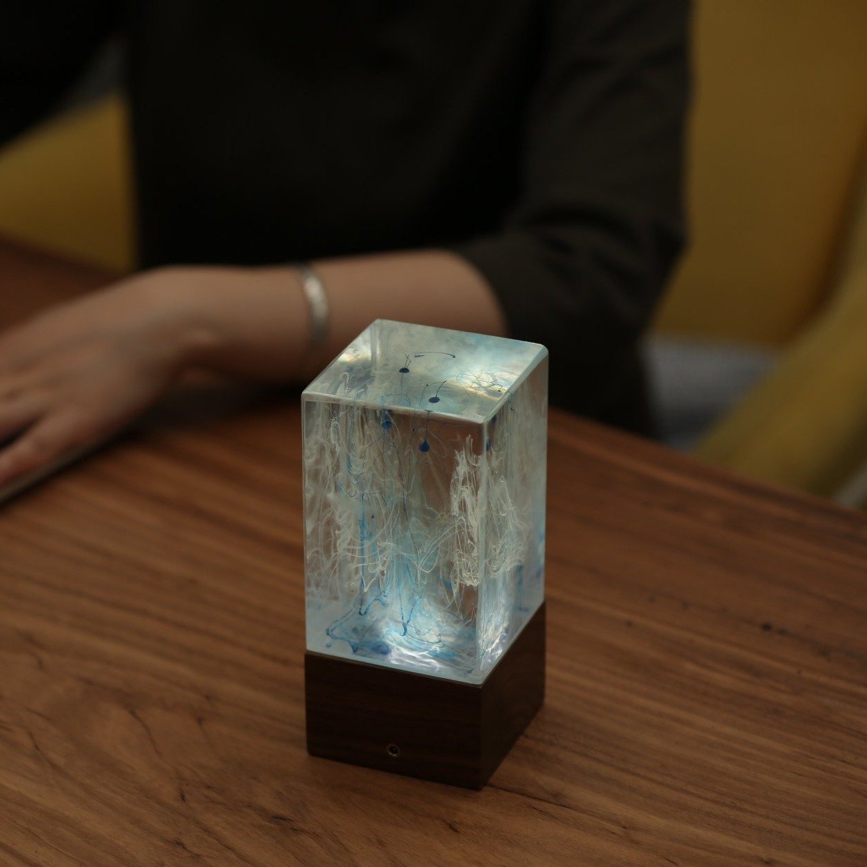 Handcrafted resin table decor featuring solar-powered LED lights in a unique design, showcasing warm white illumination.