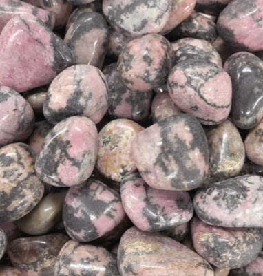 A polished Rhodonite Tumbled Stone showcasing its pink and black patterns, symbolizing emotional healing and heart chakra energy.