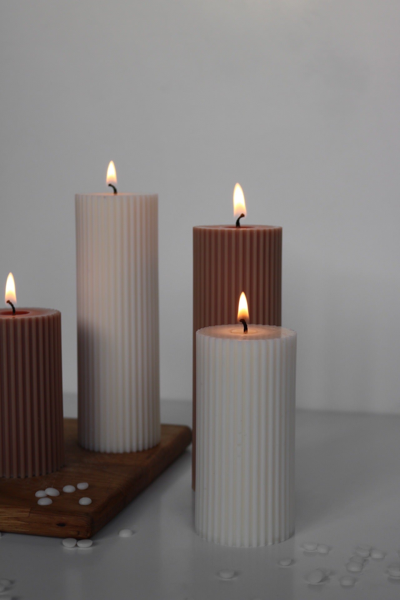 A stylish ribbed pillar candle in two sizes, showcasing its elegant design and soy wax blend material.