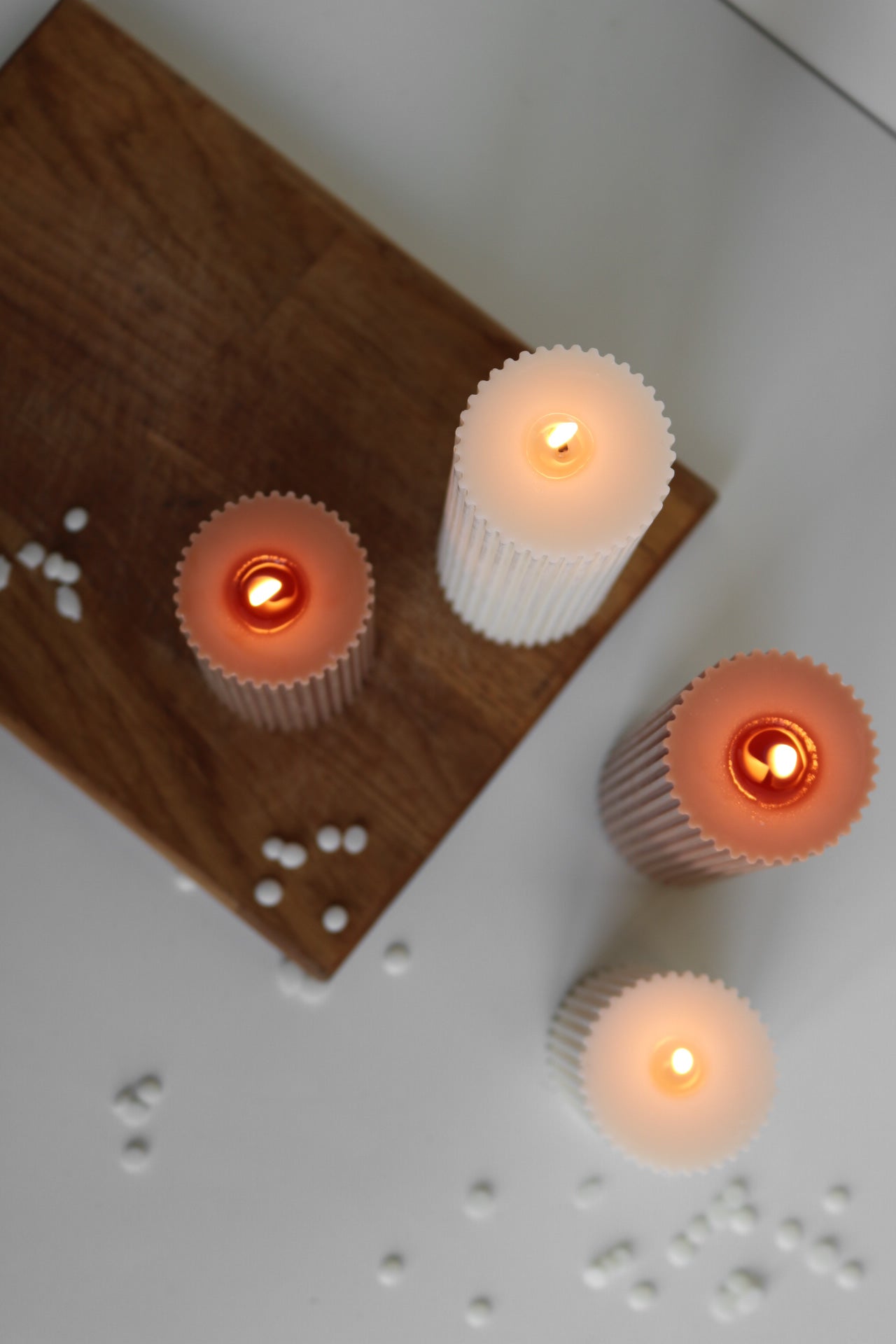 A stylish ribbed pillar candle in two sizes, showcasing its elegant design and soy wax blend material.