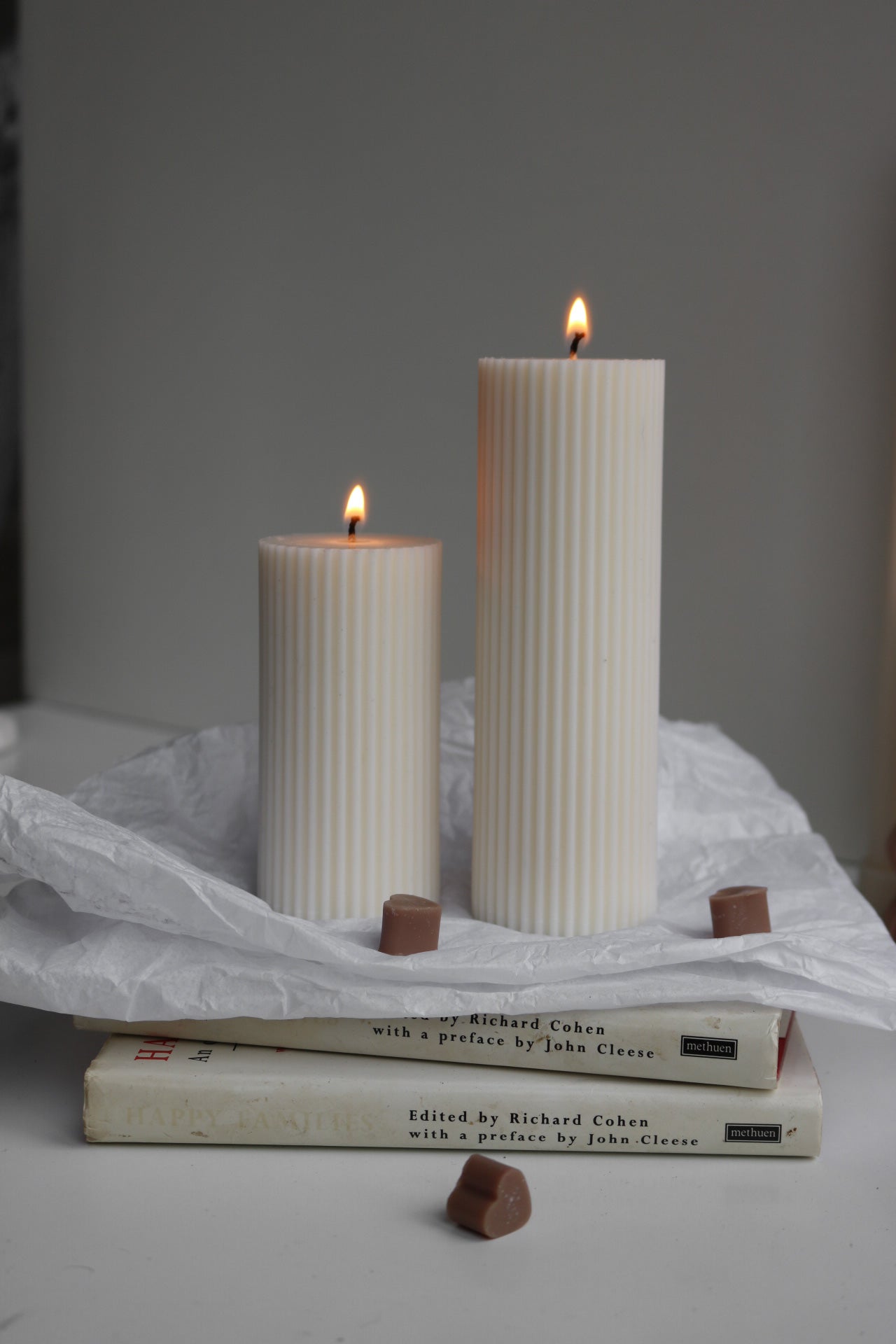 A stylish ribbed pillar candle in two sizes, showcasing its elegant design and soy wax blend material.