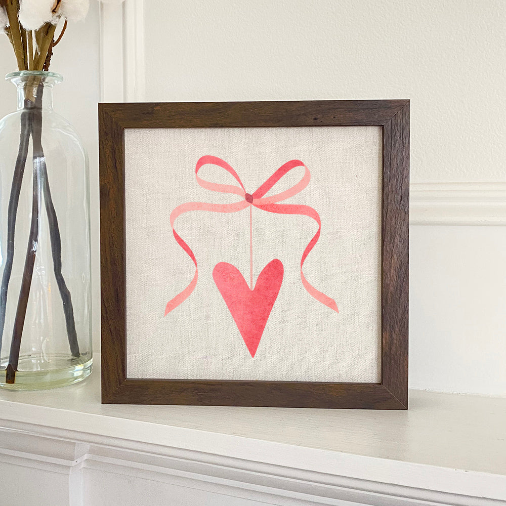 Ribbon Heart framed sign with a wood frame, eco-friendly printing on a linen-look background, available in walnut or white-washed finish.