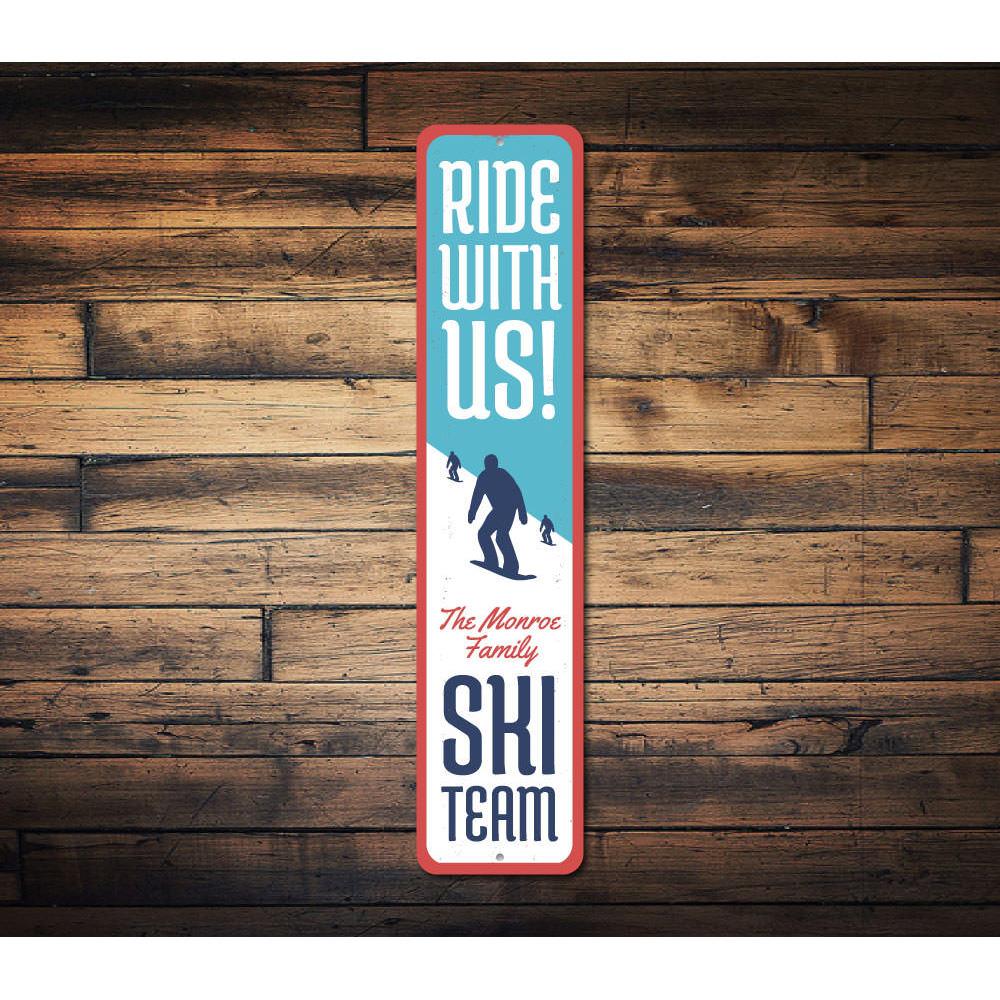 A decorative Ride With Us Skiing Sign made of high-quality aluminum, featuring a skiing theme, perfect for home or man cave decor.