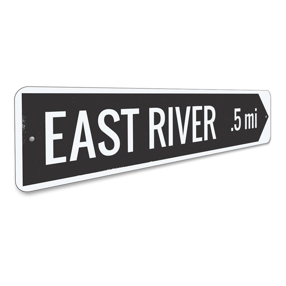 A decorative River Arrow Sign made of high-quality aluminum, featuring customizable text and pre-drilled holes for easy mounting.