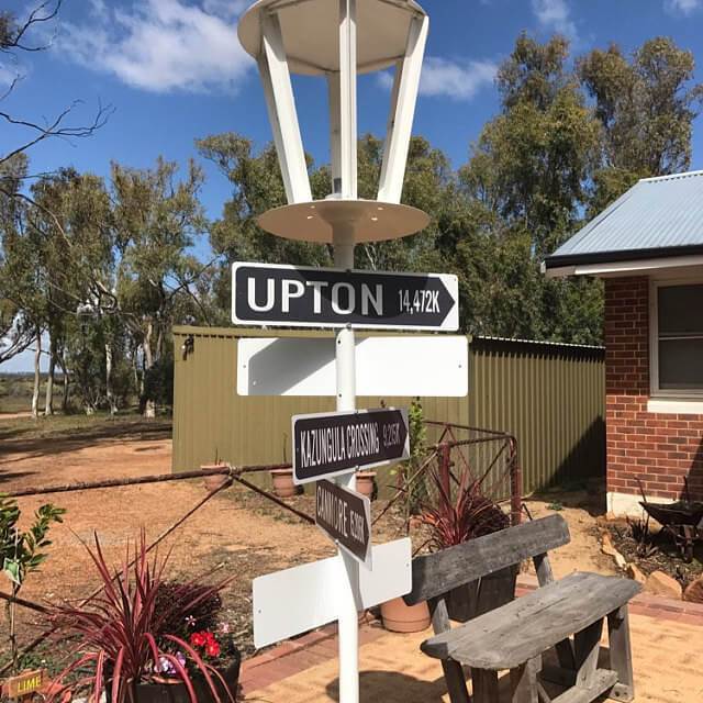 A decorative River Arrow Sign made of high-quality aluminum, featuring customizable text and pre-drilled holes for easy mounting.