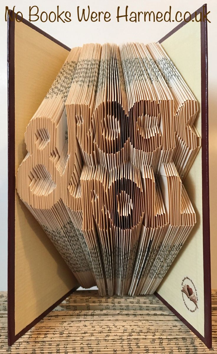 Unique ROCK & ROLL book art handcrafted from vintage pages, showcasing intricate designs and vibrant colors.