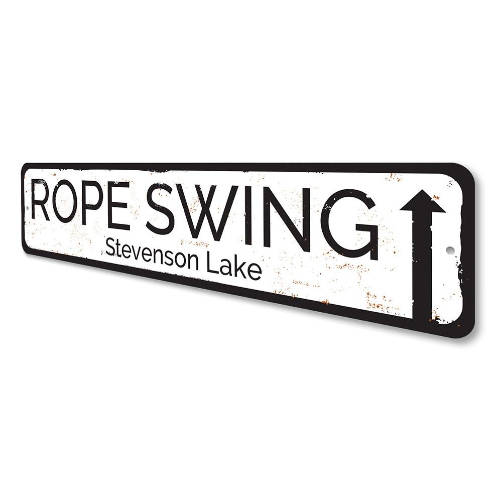 A decorative Rope Swing Sign made of durable aluminum, showcasing a rustic design perfect for lakehouse decor.