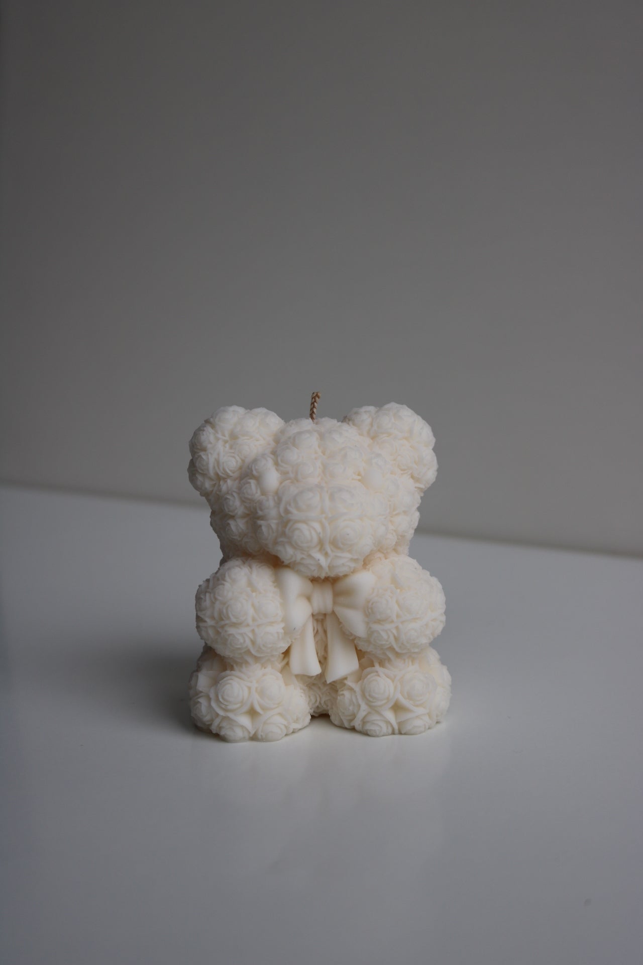 A beautifully crafted Rose bear candle, shaped like a bear and made from a soy wax blend, showcasing intricate details and a charming design.