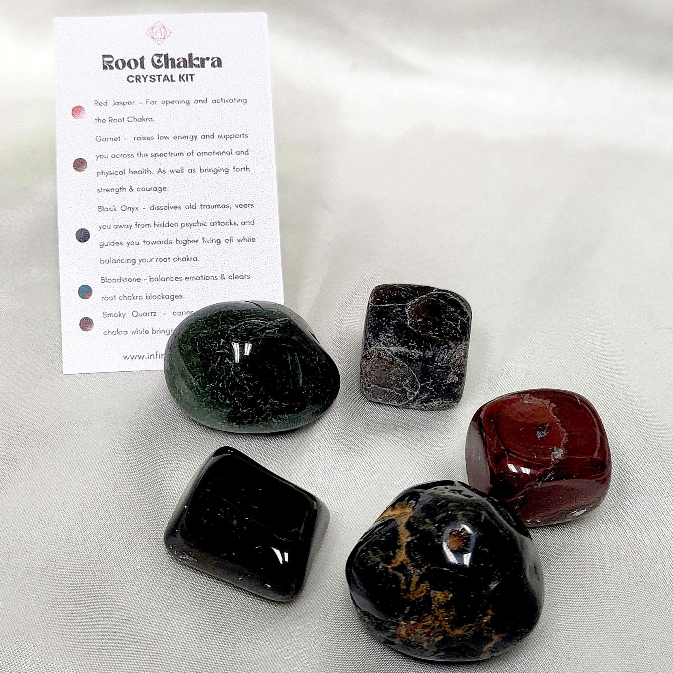 Root Chakra Crystal Kit featuring Red Jasper, Garnet, Black Onyx, Bloodstone, and Smoky Quartz, arranged beautifully for spiritual healing.