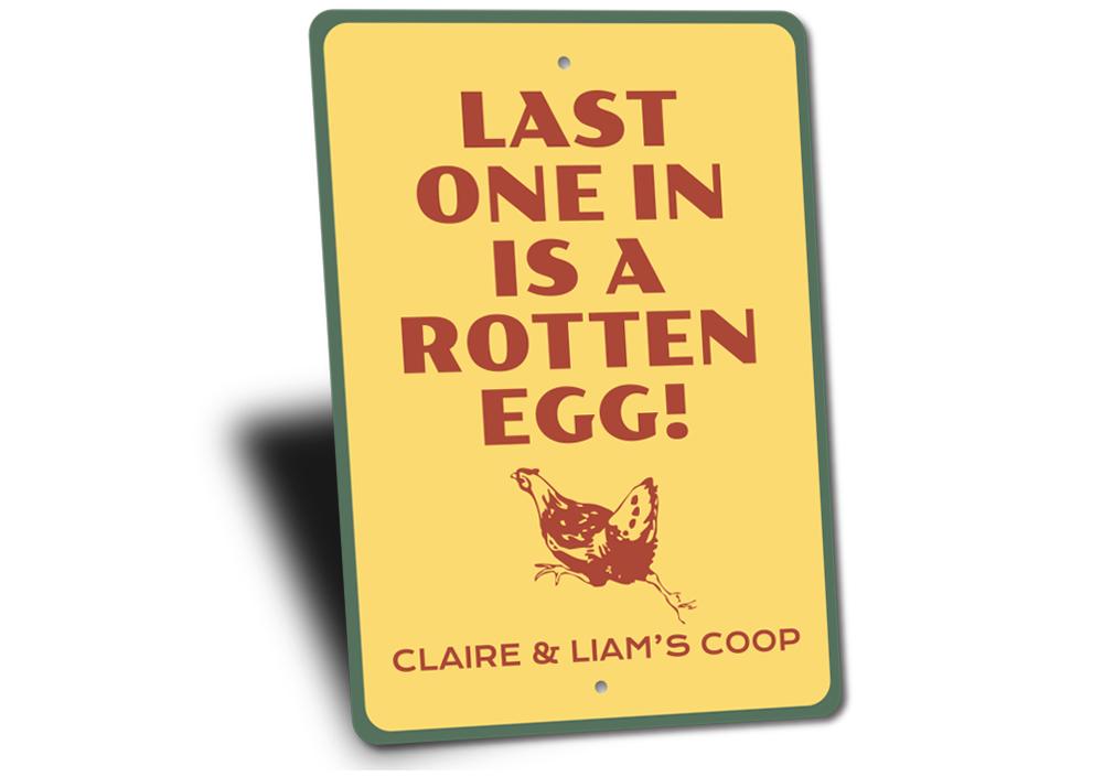 A decorative Rotten Egg Sign made of high-quality aluminum, featuring humorous text and vibrant colors, perfect for home decor.