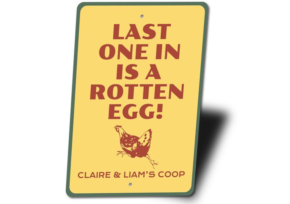 A decorative Rotten Egg Sign made of high-quality aluminum, featuring humorous text and vibrant colors, perfect for home decor.