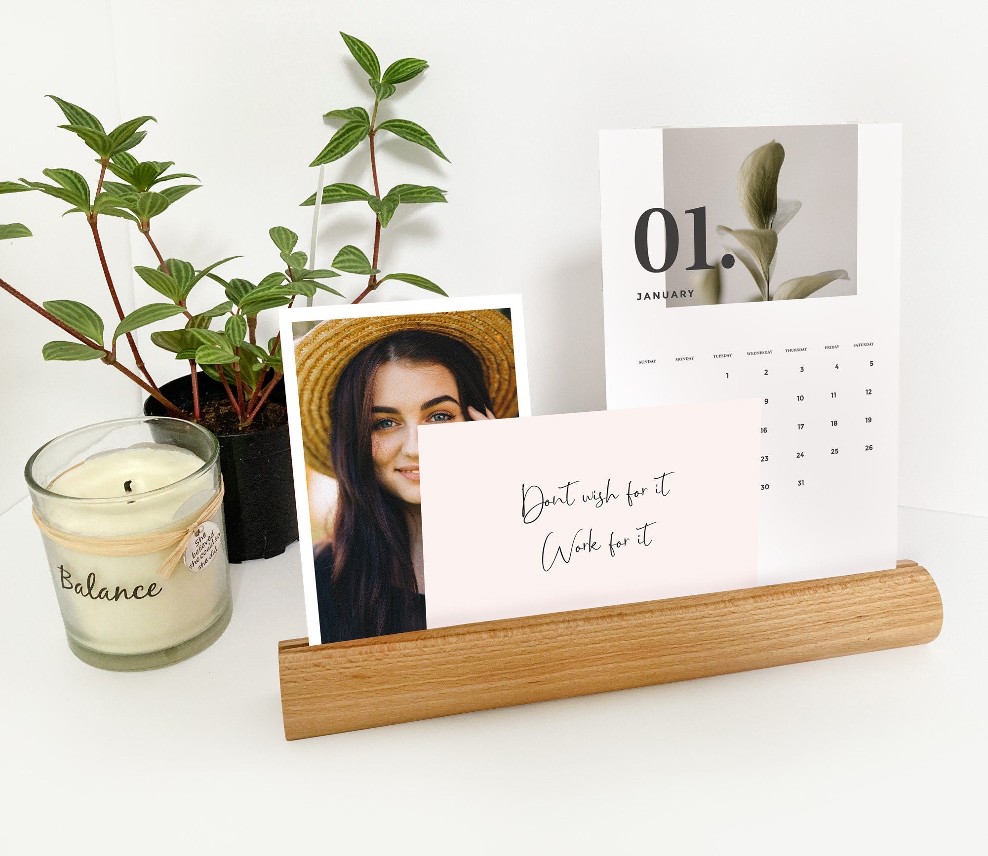 A stylish Round Wood Photo Ledge displaying various photos and notes, handcrafted from eco-friendly wood.