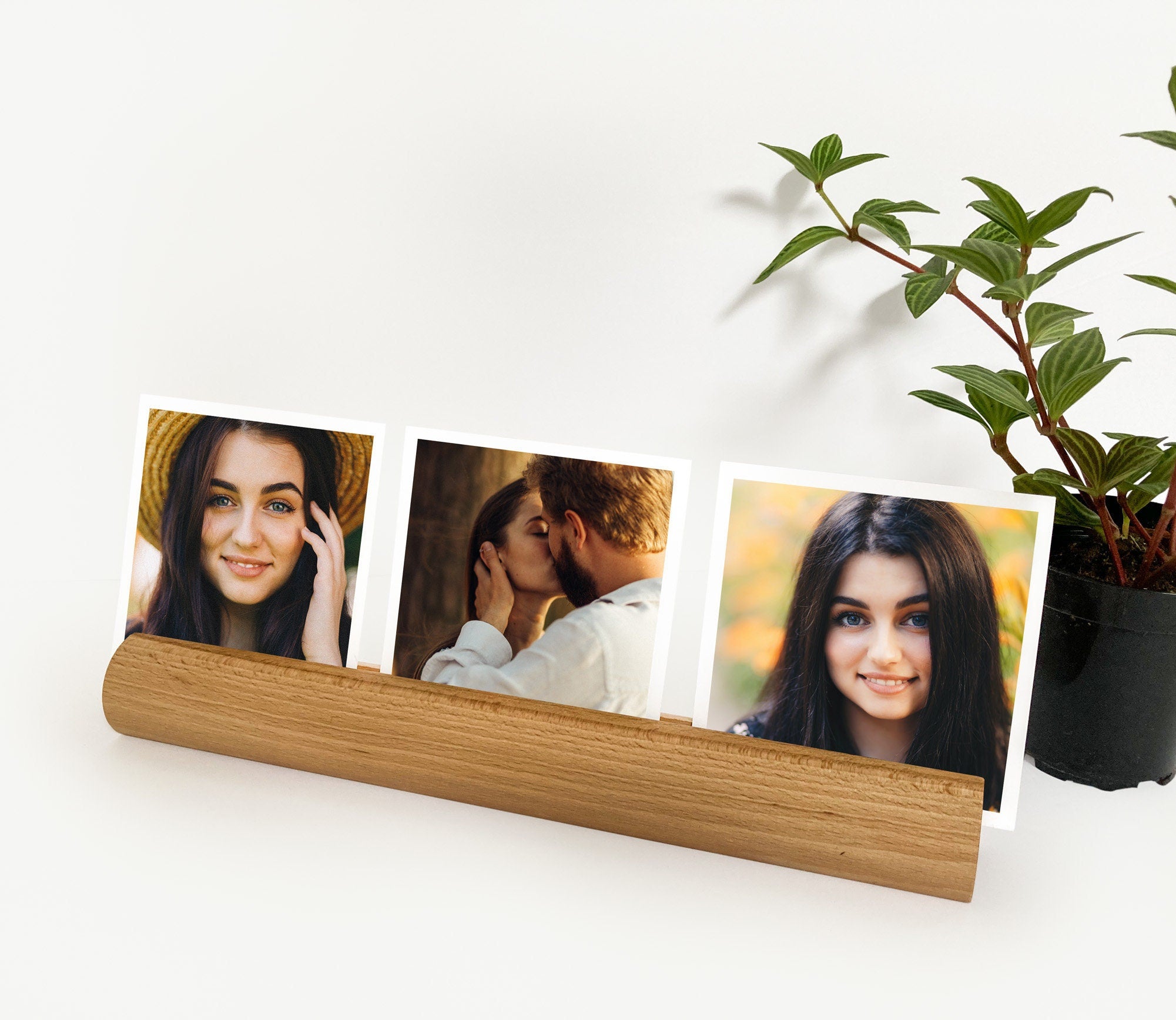 A stylish Round Wood Photo Ledge displaying various photos and notes, handcrafted from eco-friendly wood.