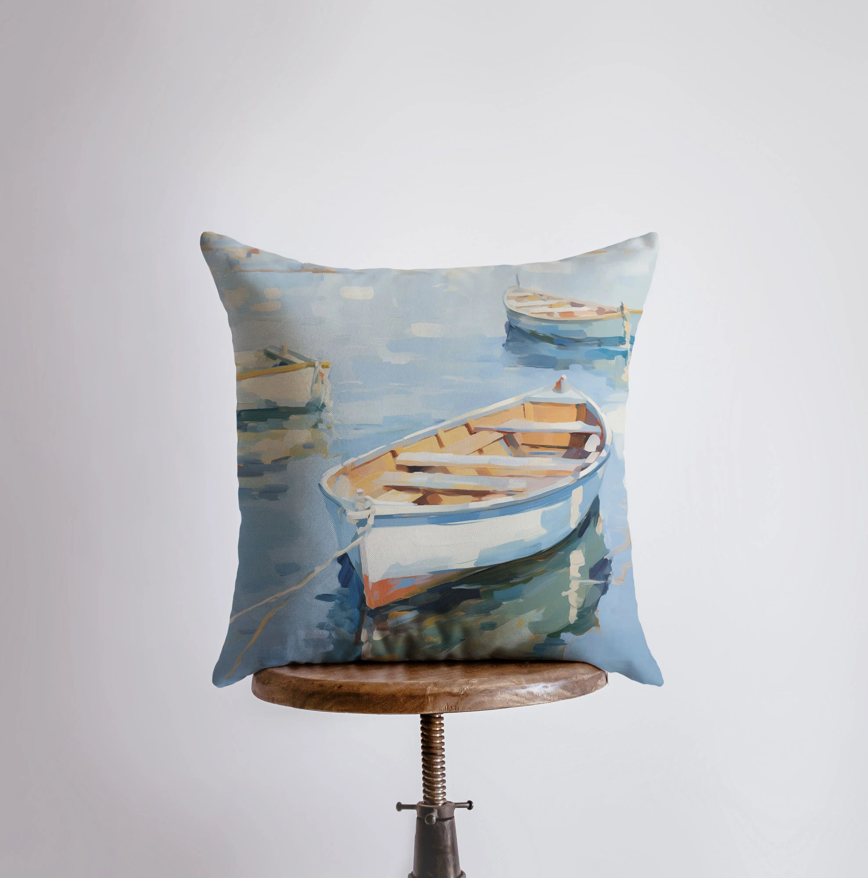 A beautifully crafted throw pillow featuring a sailboat on blue water, perfect for coastal decor.