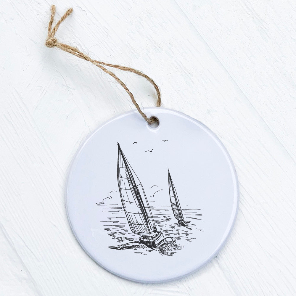 A beautiful porcelain ornament featuring sailboats on water, showcasing vibrant colors and a glossy finish.