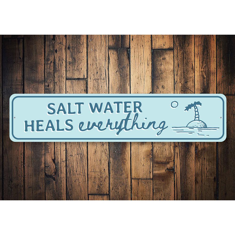 Saltwater Heals Sign made of high-quality aluminum, featuring a beach-themed design perfect for coastal decor.