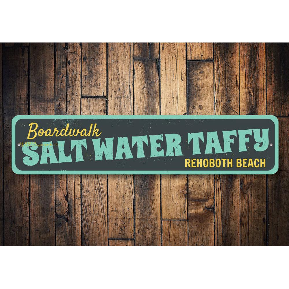 A colorful Saltwater Taffy Sign made of durable aluminum, featuring beach-themed graphics and customizable text options.