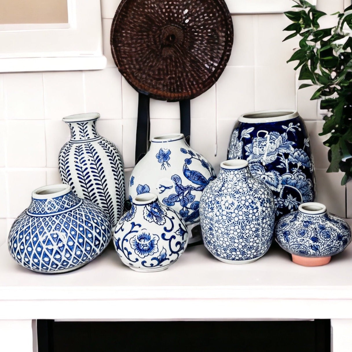 A collection of Samira Blue Vases featuring hand-painted porcelain in classic blue and white designs, showcasing various sizes and styles.