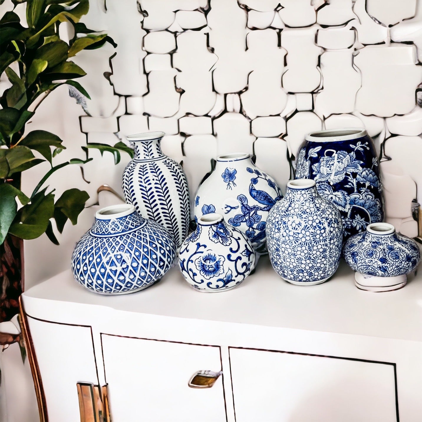 A collection of Samira Blue Vases featuring hand-painted porcelain in classic blue and white designs, showcasing various sizes and styles.