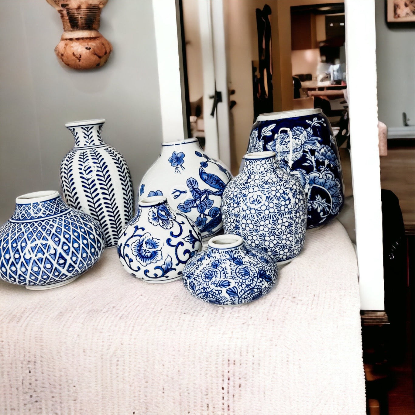 A collection of Samira Blue Vases featuring hand-painted porcelain in classic blue and white designs, showcasing various sizes and styles.